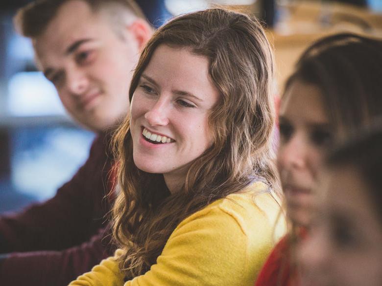 Students smiling in class.